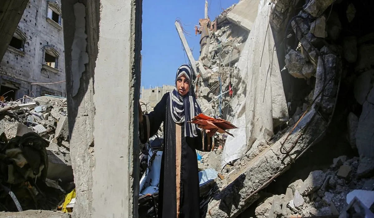 شابة فلسطينية في أطلال منزلها المدمر بغزة